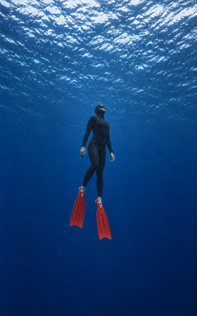 Freediver with red Lobster Fins underwater